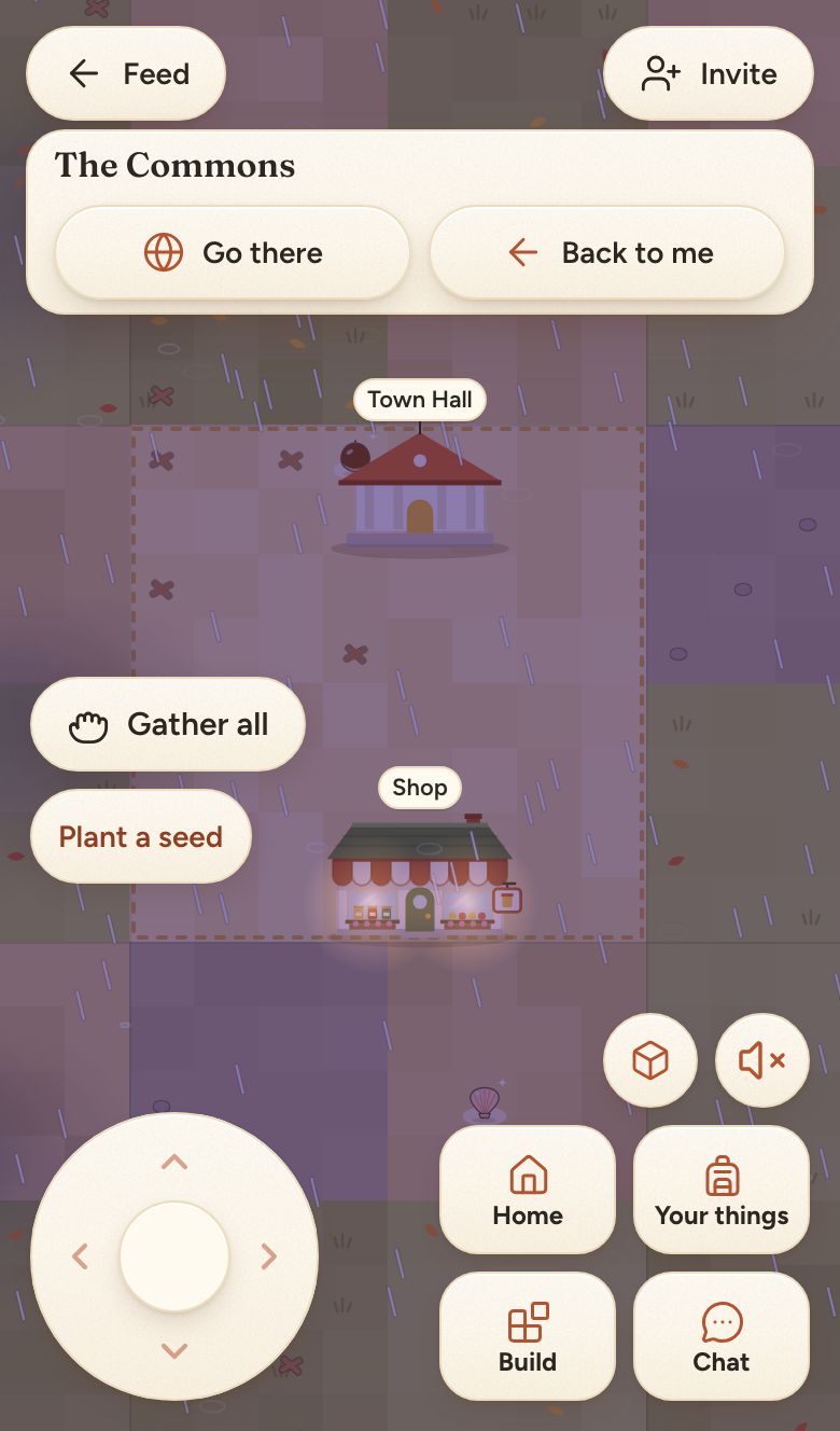 The Commons at night in the rain, the Town Hall above and the shop below, both lit, with the empty square between them